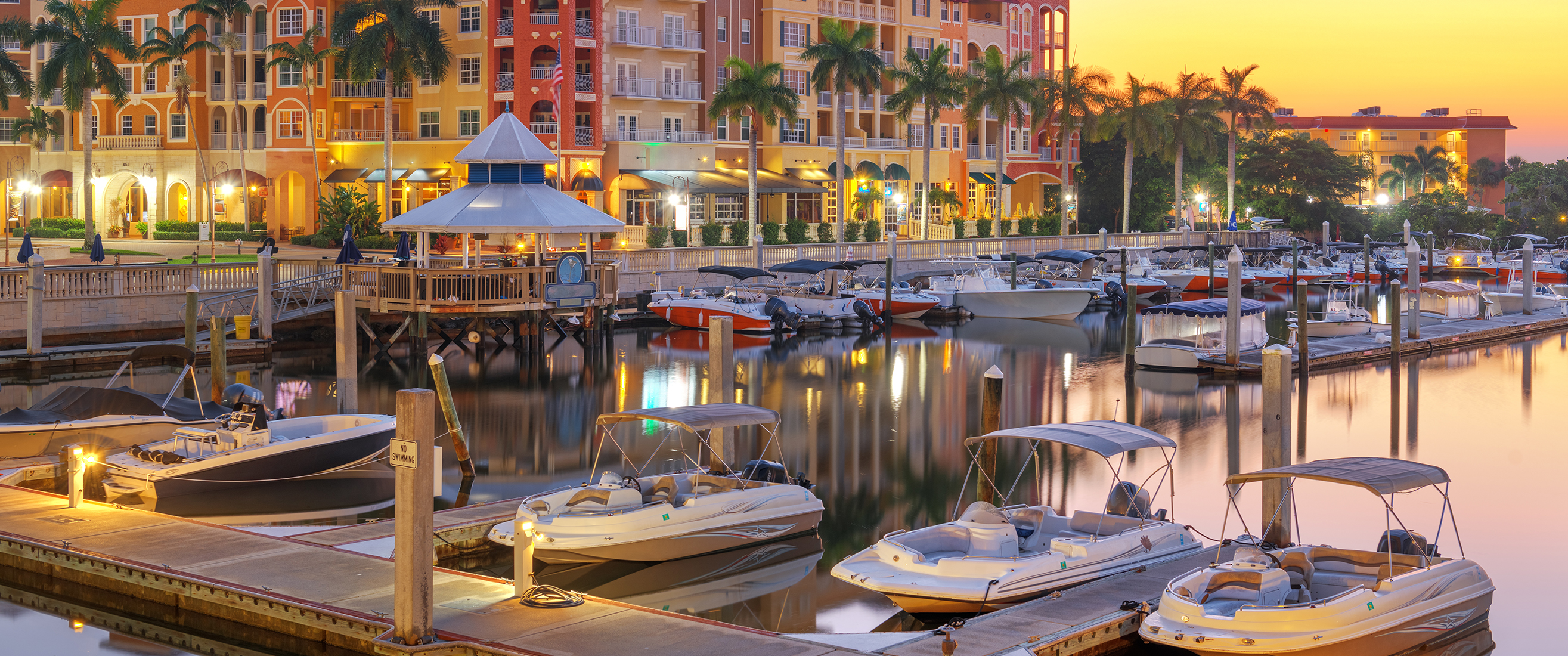 Naples, Florida, USA town skyline on the water at dawn.